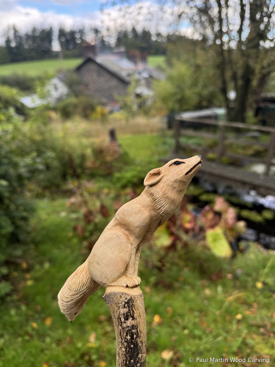 Hand carved fox on a branch
